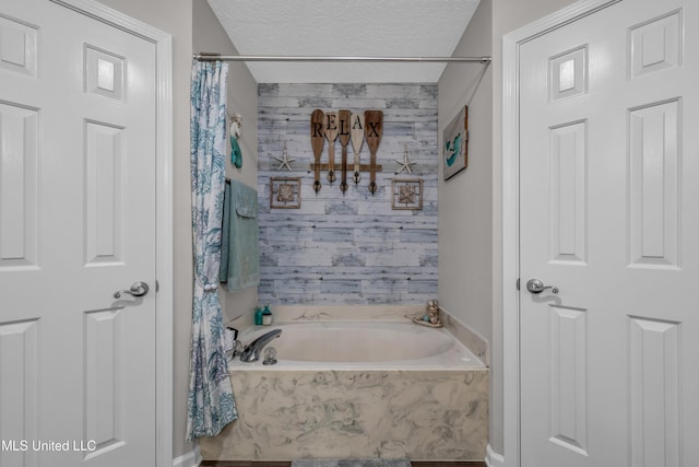 bathroom with independent shower and bath and a textured ceiling