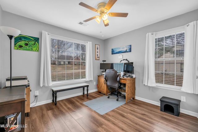 office with ceiling fan, a wealth of natural light, and hardwood / wood-style flooring