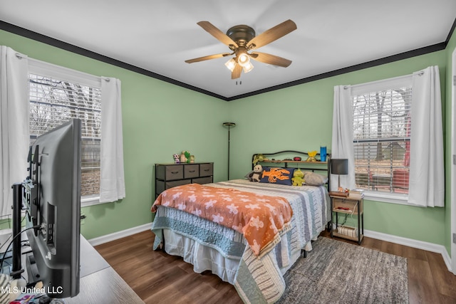 bedroom featuring ceiling fan, dark hardwood / wood-style flooring, and crown molding