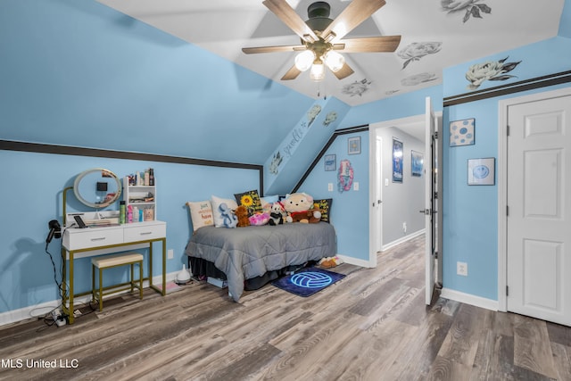 bedroom with ceiling fan, hardwood / wood-style floors, and vaulted ceiling