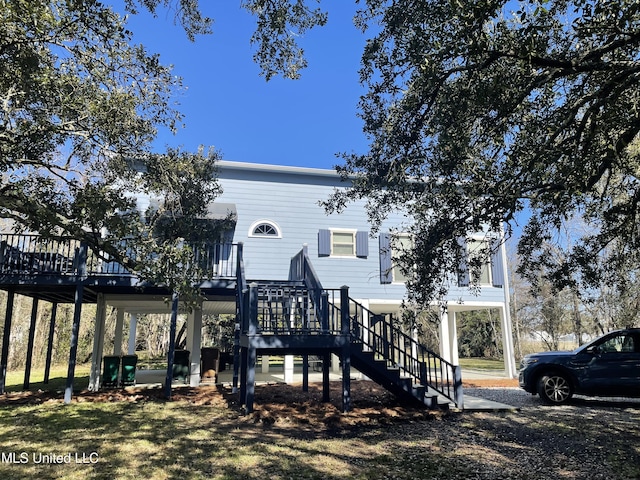 view of front of property with a carport, a deck, and stairs