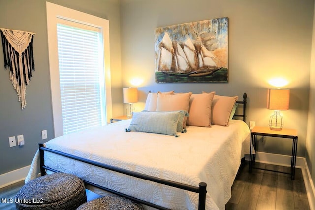 bedroom featuring wood-type flooring and baseboards