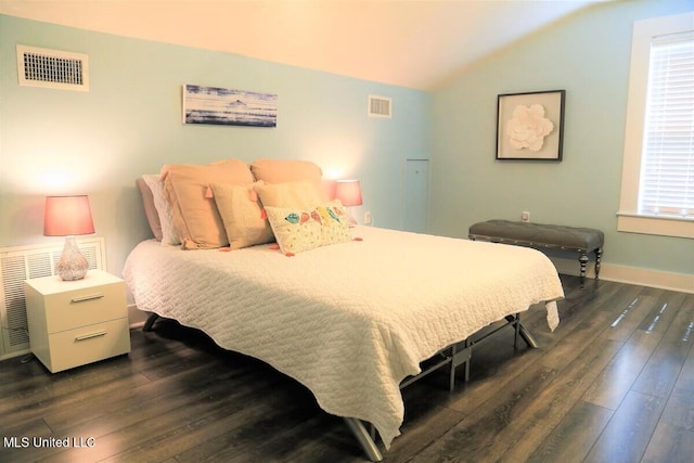 bedroom with lofted ceiling, visible vents, and dark wood finished floors