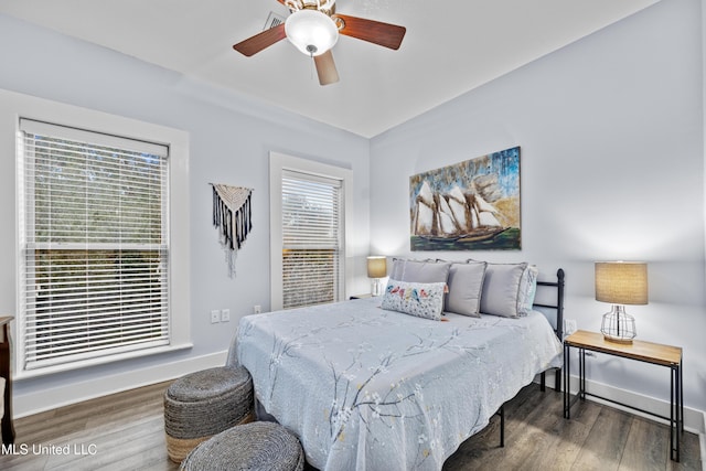 bedroom featuring wood finished floors, a ceiling fan, and baseboards