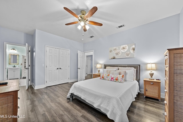 bedroom featuring a closet, dark wood finished floors, visible vents, and baseboards