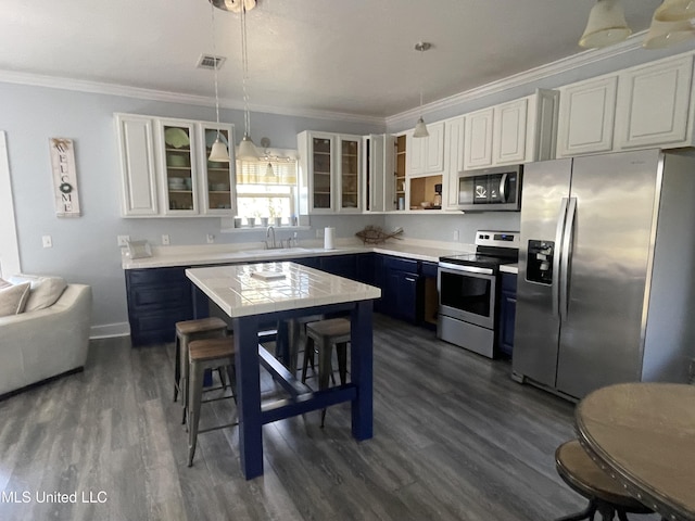 kitchen featuring visible vents, appliances with stainless steel finishes, light countertops, crown molding, and a sink