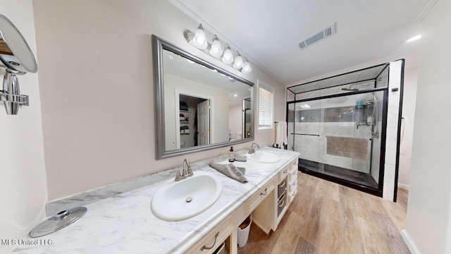 bathroom featuring vanity, a shower with shower door, and hardwood / wood-style floors