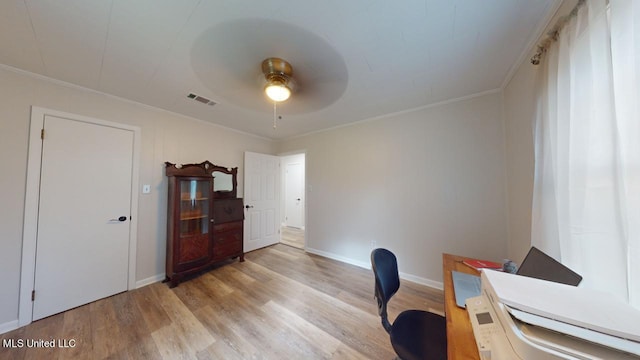 home office with ornamental molding, light hardwood / wood-style flooring, and ceiling fan