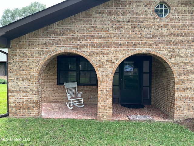 entrance to property with a yard