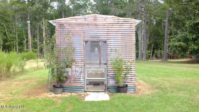 view of outbuilding with a yard