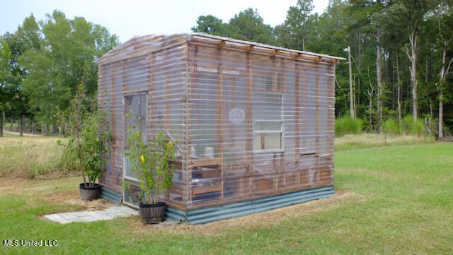 view of outbuilding featuring a yard