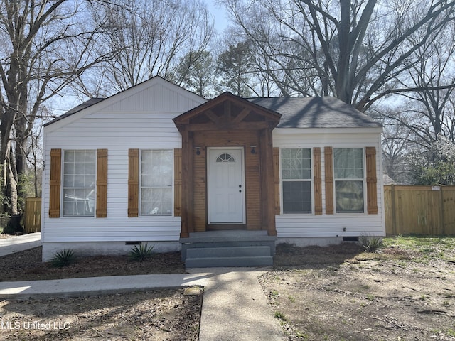 bungalow featuring a shingled roof, fence, and crawl space