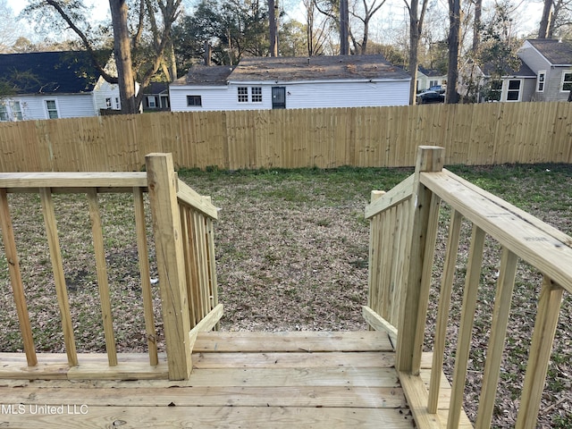 view of yard featuring a deck and fence