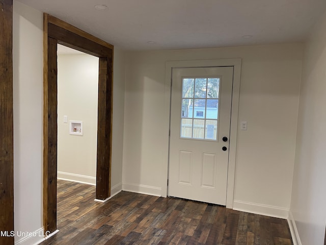 doorway with baseboards and dark wood-style flooring