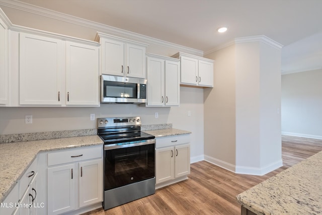 3786 Roland Dr, Southaven, MS 38672 - kitchen featuring white cabinets, baseboards, ornamental molding, appliances with stainless steel finishes, and light wood finished floors