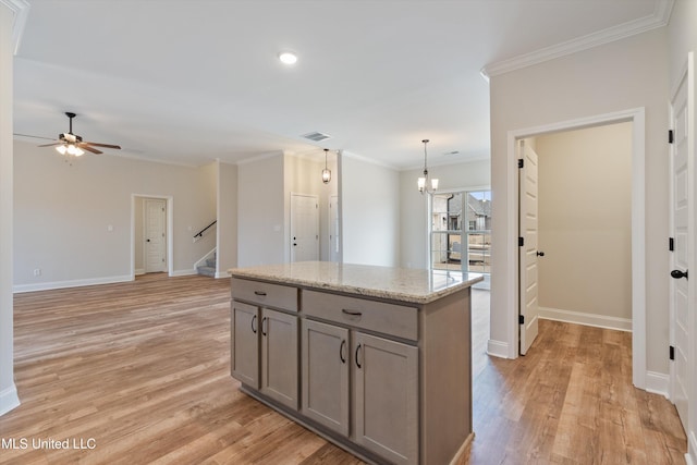 3786 Roland Dr, Southaven, MS 38672 - kitchen with light wood finished floors, gray cabinetry, and ornamental molding