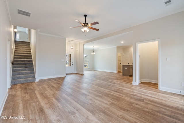 3786 Roland Dr, Southaven, MS 38672 - unfurnished living room featuring visible vents, baseboards, light wood-style floors, ceiling fan with notable chandelier, and stairs