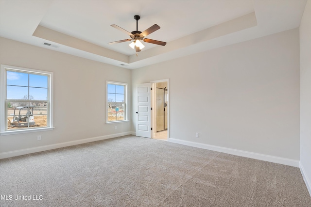 3786 Roland Dr, Southaven, MS 38672 - spare room with ceiling fan, light colored carpet, visible vents, a raised ceiling, and baseboards