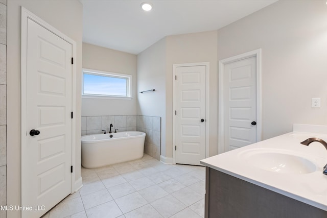 3786 Roland Dr, Southaven, MS 38672 - full bath featuring a freestanding tub, double vanity, a sink, and tile patterned flooring