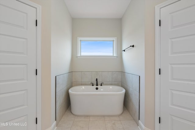 3786 Roland Dr, Southaven, MS 38672 - bathroom featuring tile patterned flooring, tile walls, and a soaking tub