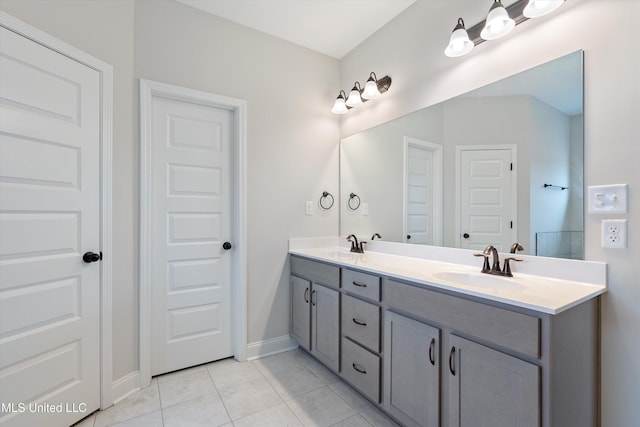 3786 Roland Dr, Southaven, MS 38672 - full bath featuring tile patterned floors, double vanity, a sink, and baseboards