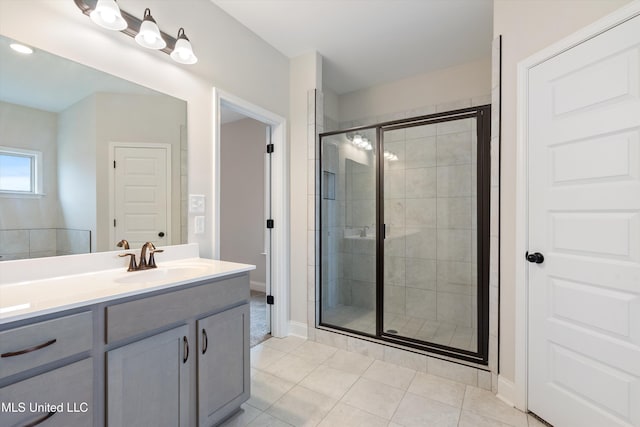 3786 Roland Dr, Southaven, MS 38672 - bathroom with a shower stall, tile patterned floors, vanity, and baseboards