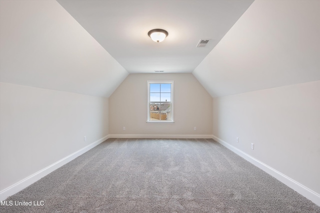 3786 Roland Dr, Southaven, MS 38672 - additional living space with visible vents, baseboards, carpet flooring, and lofted ceiling