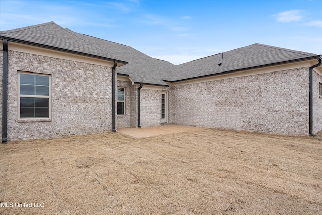 3786 Roland Dr, Southaven, MS 38672 - rear view of house featuring a shingled roof and brick siding