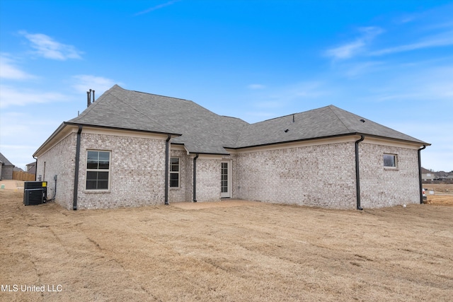 3786 Roland Dr, Southaven, MS 38672 - rear view of property featuring central air condition unit, a shingled roof, and brick siding