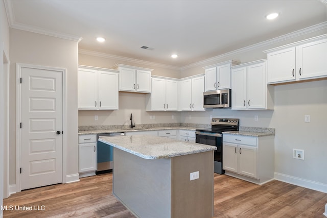 3786 Roland Dr, Southaven, MS 38672 - kitchen with light wood-type flooring, white cabinetry, visible vents, and stainless steel appliances