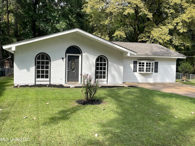 ranch-style home with a front lawn