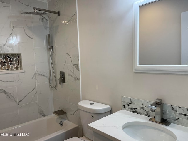 full bathroom with vanity, toilet, tasteful backsplash, and tiled shower / bath combo