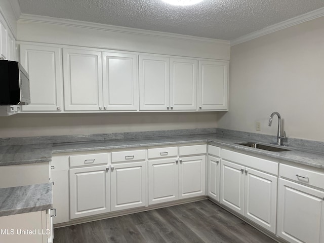 kitchen featuring white cabinetry, crown molding, sink, and dark hardwood / wood-style flooring