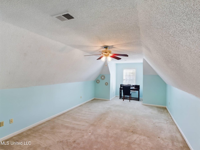 bonus room featuring baseboards, visible vents, a ceiling fan, lofted ceiling, and carpet flooring