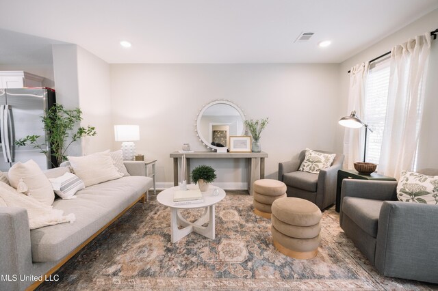living area featuring visible vents and recessed lighting