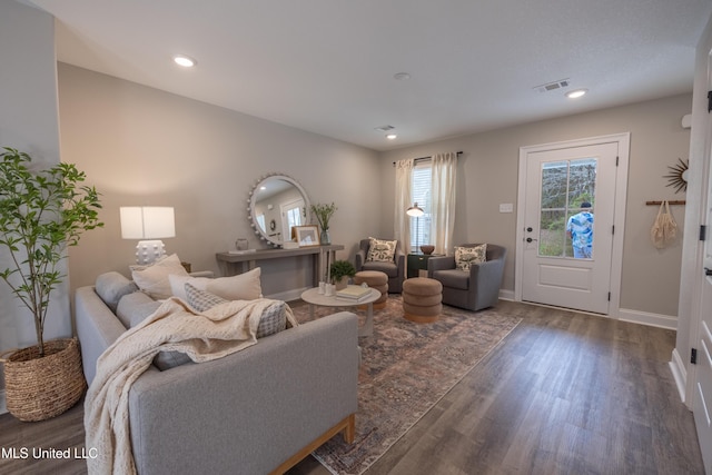 living room featuring recessed lighting, visible vents, baseboards, and wood finished floors