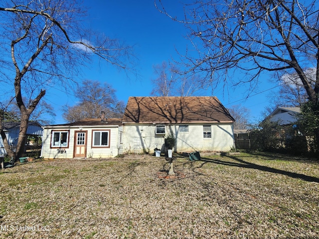 back of house with a lawn