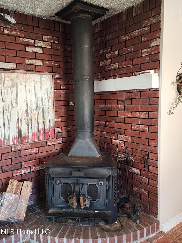 details featuring a textured ceiling and a wood stove