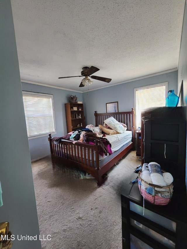 bedroom featuring crown molding, ceiling fan, carpet flooring, and a textured ceiling