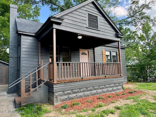 319 S 4th St, Mccomb, MS 39648 - shotgun-style home with covered porch and a chimney