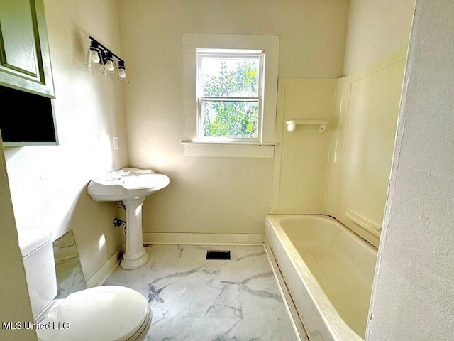 319 S 4th St, Mccomb, MS 39648 - full bathroom with toilet, marble look tiles, and baseboards