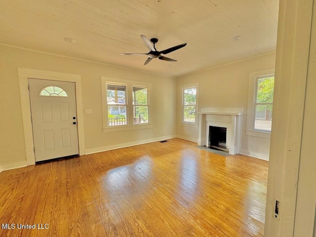 319 S 4th St, Mccomb, MS 39648 - unfurnished living room with wood finished floors, healthy amount of natural light, ceiling fan, a fireplace, and ornamental molding