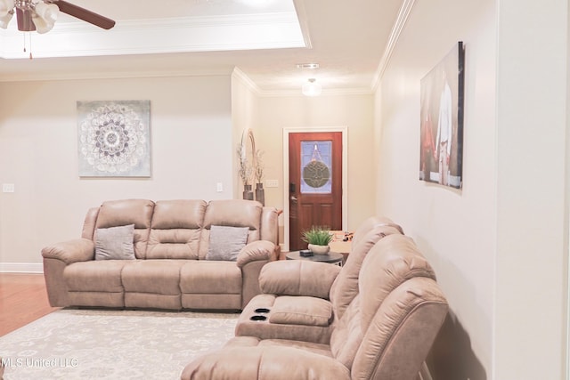 living room featuring ornamental molding, wood-type flooring, and ceiling fan