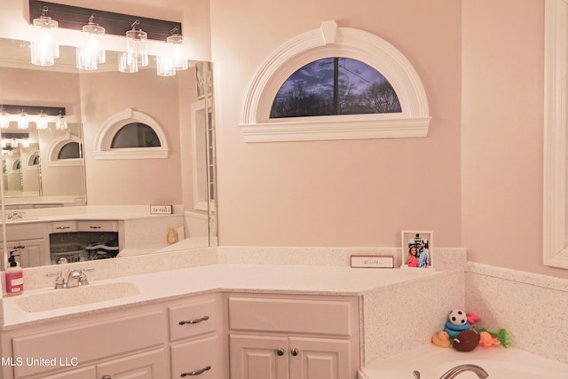 bathroom featuring vanity and a tub to relax in