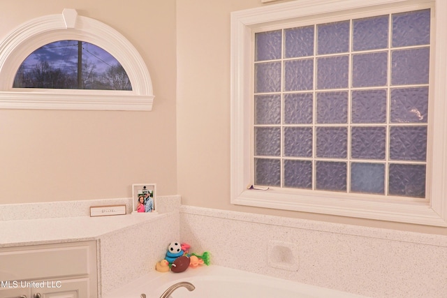 bathroom with a tub to relax in