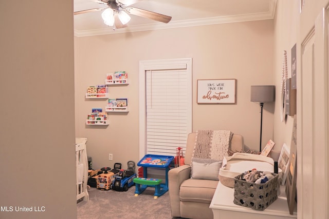 rec room with ornamental molding, ceiling fan, and carpet