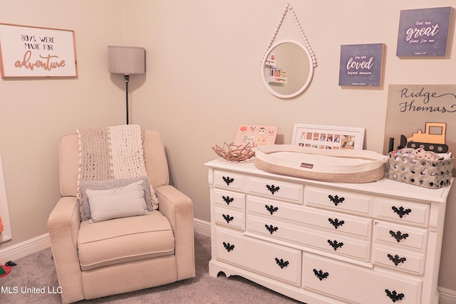 sitting room featuring light colored carpet