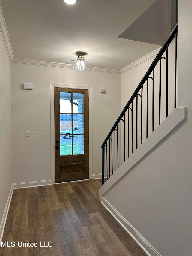 foyer entrance with dark hardwood / wood-style flooring and ornamental molding