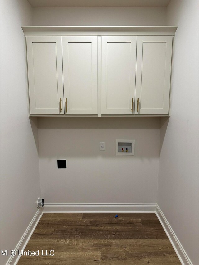 laundry room featuring washer hookup, hookup for an electric dryer, cabinets, and dark wood-type flooring