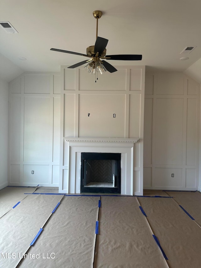 unfurnished living room featuring vaulted ceiling and ceiling fan